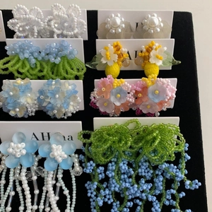Handmade floral seed bead earrings collection featuring chiffon flowers and colorful tassels