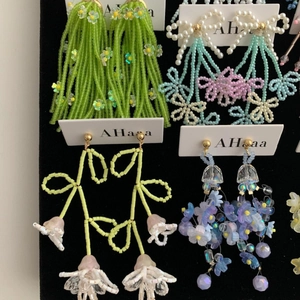 Handmade beaded earrings featuring chiffon flowers and tassels in a vibrant color display.