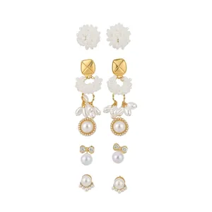 Elegant 5-pair pearl and gold earring set featuring flower clusters and bow designs