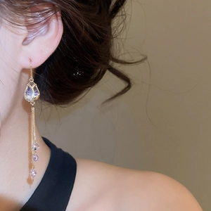 Close-up detail of 18k gold plated flower tassel earrings with elegant purple crystal beads