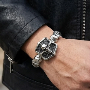 Macro shot of a punk-style skull and cross shield titanium steel bracelet for men