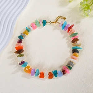 Detailed macro view of colorful irregular acrylic bead necklace for stylish summer beach wear