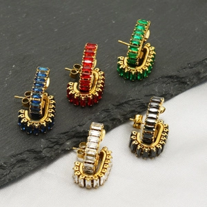 Detailed macro view of C-shaped hoop earrings with multi-colored baguette-cut zircons