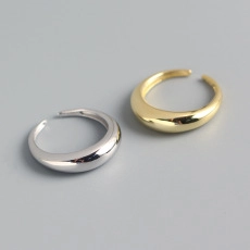 Top view of gold and silver minimalist open rings with thick polished teardrop design