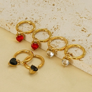 Three pairs of hoop earrings with heart-shaped pendants in red, black, and clear crystals