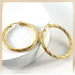 Close-up of 18K gold plated stainless steel hoop earrings with elegant twisted rope texture