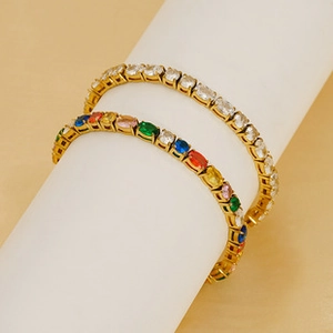 Close-up of gold plated tennis bracelets with white and multi-color zircon stones