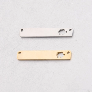 Detail of rectangular stainless steel elephant charms in gold and silver finishes