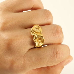 Macro detail of adjustable 18k gold plated stainless steel ring with lava texture finish