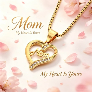 Macro shot of gold heart pendant with Mom lettering and pavé crystals on a floral base