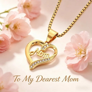 Detail of gold heart pendant with Mom lettering and rhinestones on a box chain
