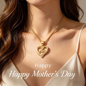Detail shot of a golden Mom heart necklace with sparkling diamonds on a silk top