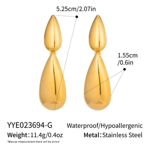 Macro detail of gold water drop earrings showing dimensions and stainless steel quality