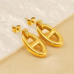 Detail of 18k gold plated stainless steel stud earrings with polished anchor link design