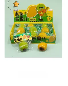 Close-up of color-changing mango squishy toy in bulk display box with vibrant yellow fruit