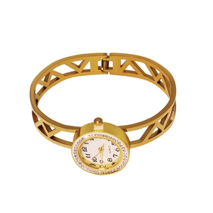 Detail view of a gold-plated open hollow bangle watch with white rhinestones and quartz dial