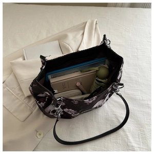 Detail view of large gothic floral tote bag interior showing ample storage for daily items