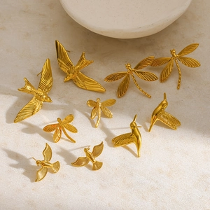 Golden 18K gold-plated stainless steel dragonfly and swallow stud earrings on stone