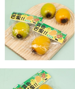 Close-up of color-changing mango squishy stress toy showing yellow and green variants