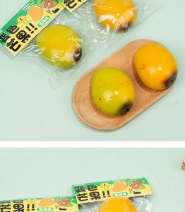 Macro detail of color-changing mango squishy toy in its packaging on a green background