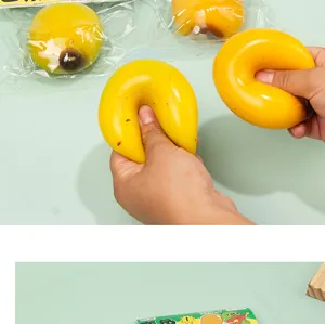 Detailed view of the yellow squeeze mango toy showing high elasticity and soft texture
