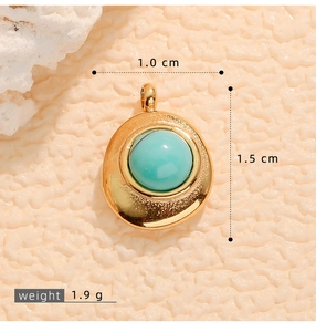 Macro shot of gold-plated pendant with turquoise stone showing 1cm width and 1.5cm height