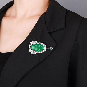 Elegant Chinese style fan brooch with green jade and gemstones on black suit blazer