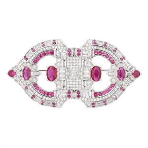 Macro shot of Art Deco silver brooch with oval red rubies and sparkling zircon stones