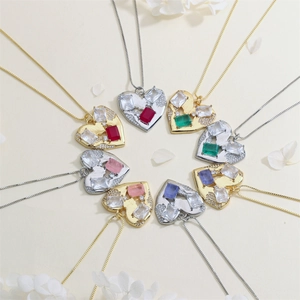 Macro view of assorted heart pendants with colorful zircon stones on gold and silver chains