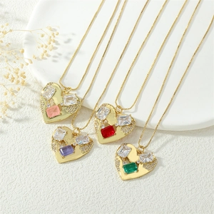 Macro shot of 18K gold heart-shaped pendants with colorful zircon gemstones in four colors