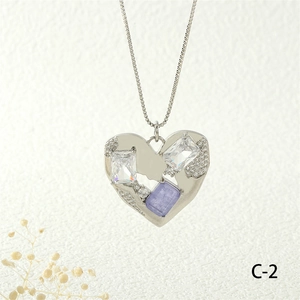 Detail of silver heart pendant with baguette-cut zircons and box chain necklace