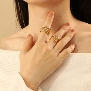 Detail of 18K gold-plated multi-layer geometric rings with white cubic zirconia stones