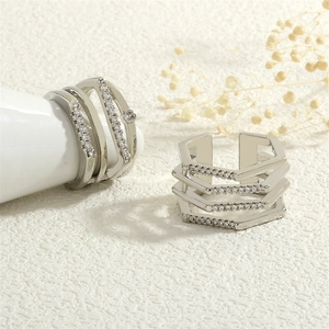 Detail view of multi-layer geometric silver rings with sparkling cubic zirconia inlay