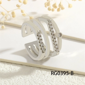 Detailed close-up of triple-layered geometric silver ring with sparkling white zircons