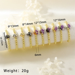 Detail of Halloween gold bead bracelets with skull and witch hat enamel charms