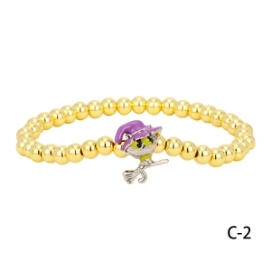 Detail of Halloween beaded bracelet with flying cat wizard pendant and gold plated beads