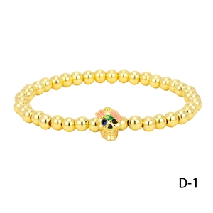 Halloween gold beaded bracelet with sugar skull charm and colorful floral details