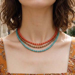 Three-layer bohemian beaded necklace set with red, brown, and blue cylinder beads