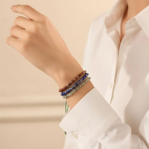 Detailed shot of three colorful semi-precious stone beaded bracelets on a model wrist