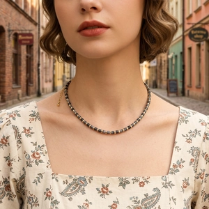 Detailed macro view of semi-precious stone beaded necklace with gold adjustable chain