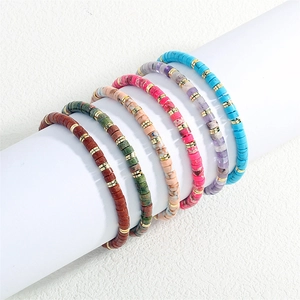 Close-up of bohemian disc bead bracelets with golden spacers in a 6-piece assorted set