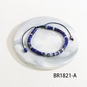 Detailed view of dark blue beaded bracelet with adjustable woven rope and stone beads