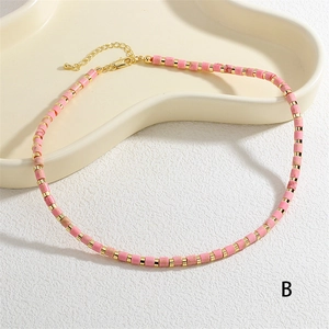 Close-up of pink stone beads and gold metal spacers on this elegant handmade choker