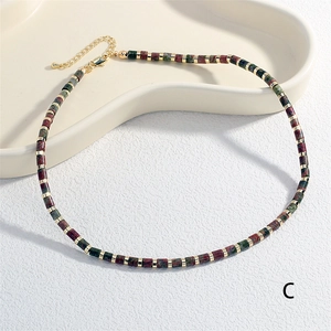 Detail showing multi-colored semi-precious beads with gold spacers and lobster clasp