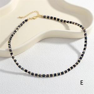 Macro detail of handmade semi-precious stone beaded necklace with gold spacer beads