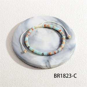 Macro shot of semi-precious stone barrel beads with adjustable woven strap detail