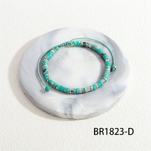 Detail of handmade woven bracelet featuring natural marble stones and silver spacers