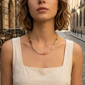 Handmade beaded necklace with natural semi-precious stones and gold beads on a female model