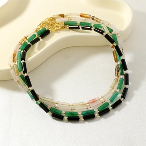 Detail of multi-layer beaded necklace with semi-precious stones and golden metal spacers