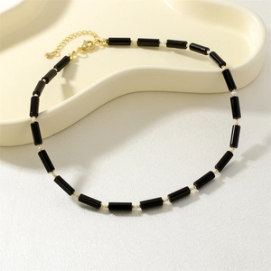 Detailed view of handmade gemstone necklace with golden lobster clasp and beads